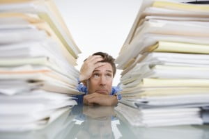 Businessman Overwhelmed with Paperwork